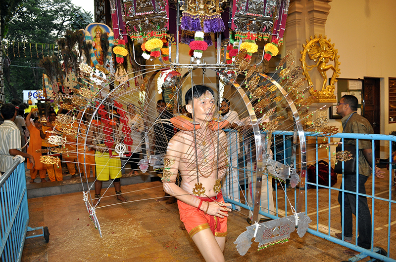 A Chinese kavadi bearer arriving at the Sri Thendayuthapani Temple, the culmination point of the Thaipusam foot procession, 2014. Chettiars’ Temple Society Collection, courtesy of National Archives of Singapore.